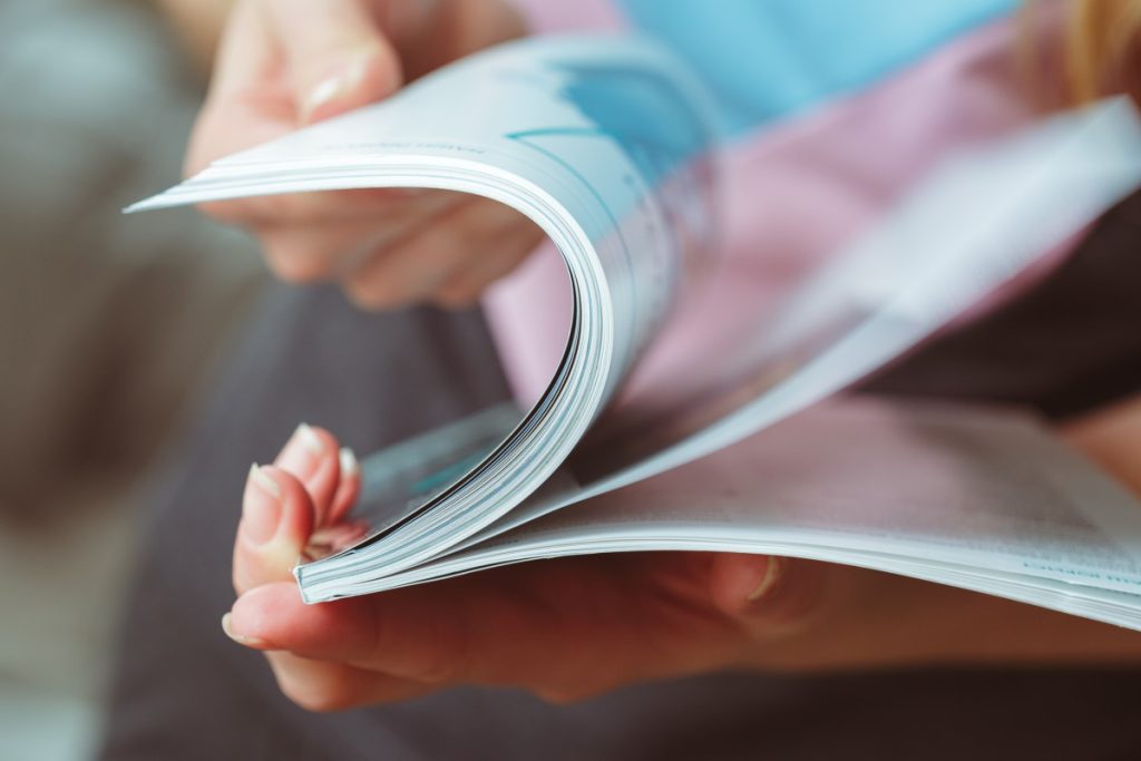 A woman flipping through a magazine