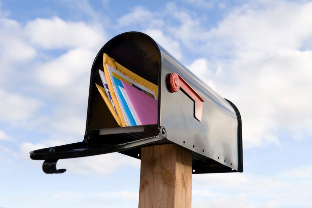 An open mailbox with mail inside