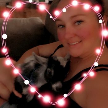 Sara Miller with a heart filter border. She is also holding a baby goat