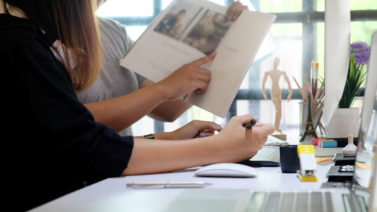 Two designers working on a magazine