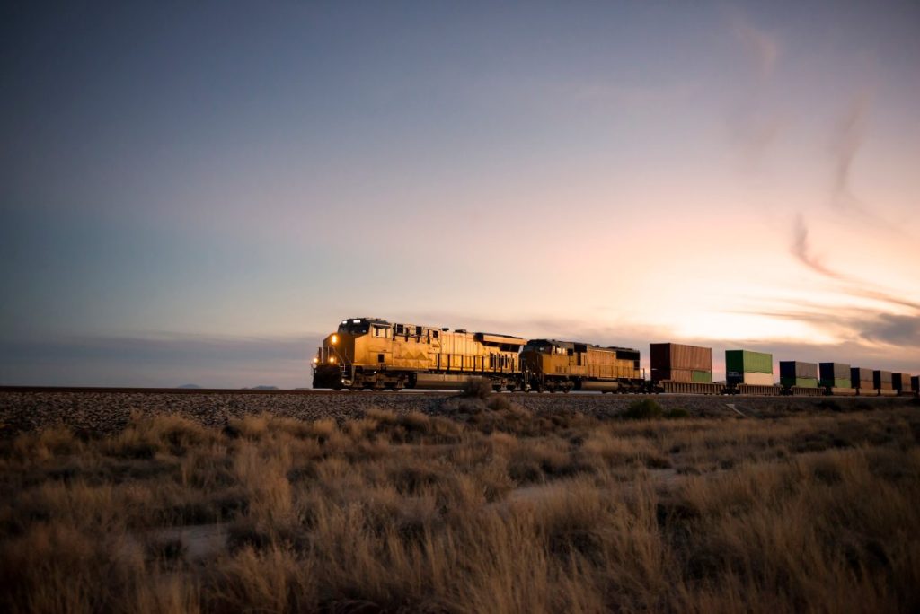 A train moving through the desert at dawn