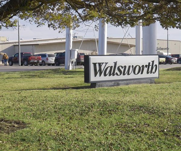 A large sign that says Walsworth in front of the building used to print books, magazines and catalogs