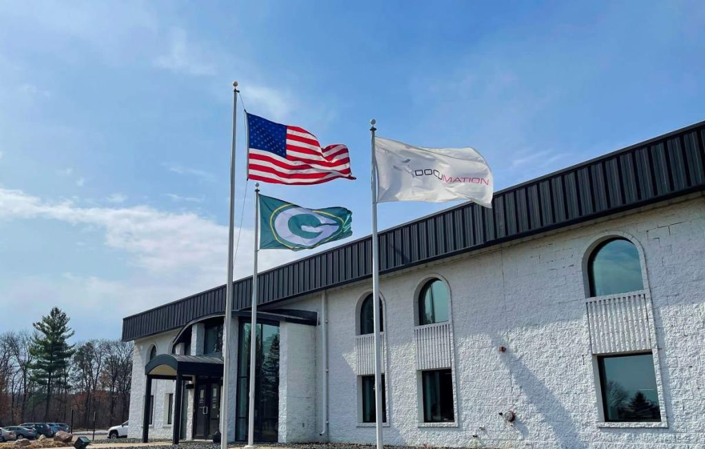 Three flags flying in front of Documation in Eau Claire, WI